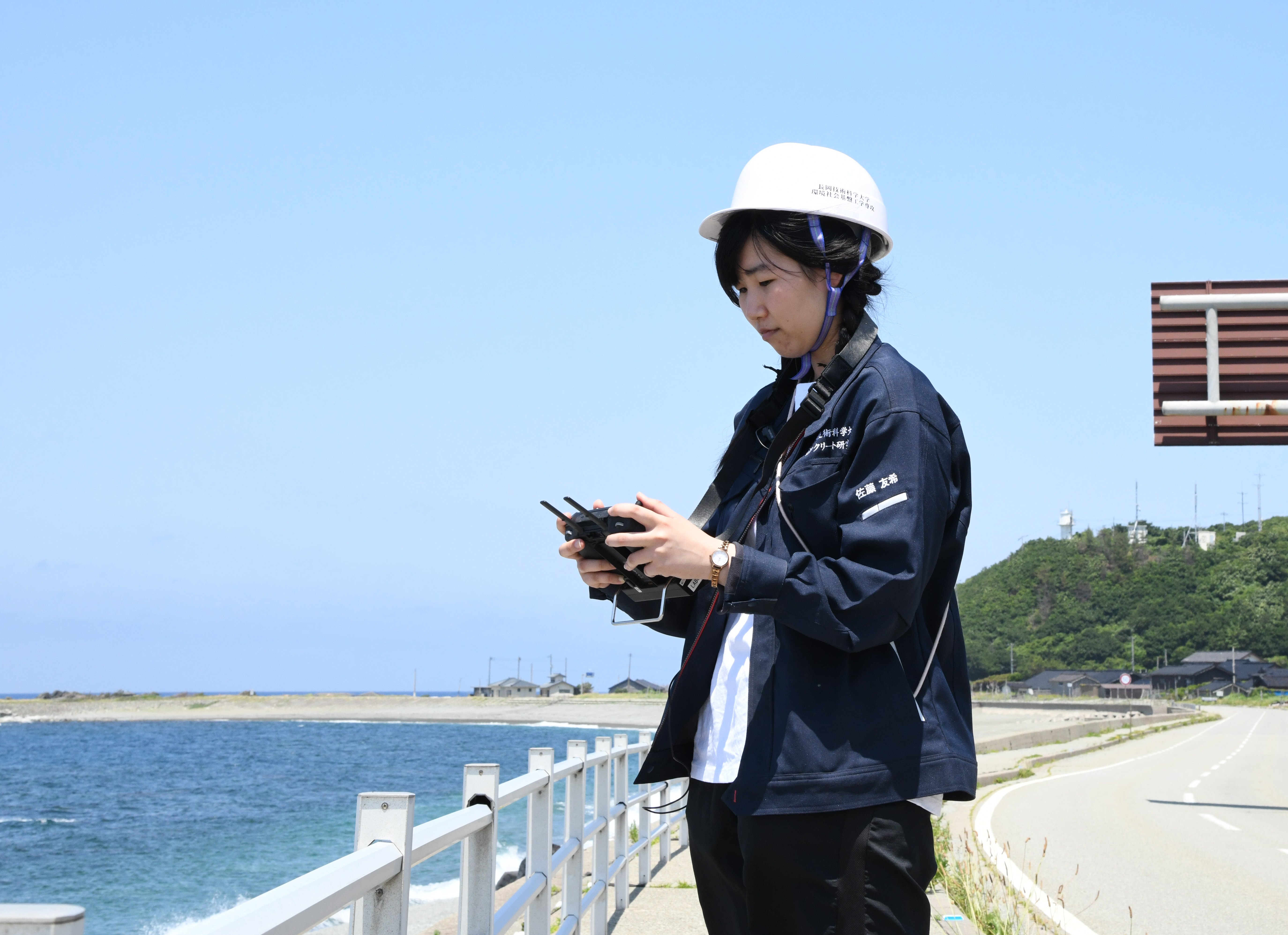 研究室の学生がドローンを利用して構造物を測定している様子